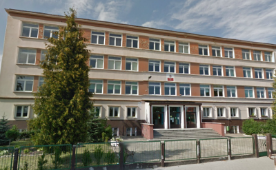 Współczesne zdjęcie. Przedstawia widok na odnowiony budynek i wejście. Przed szkołą ogrodzenie. Jest to Szkoła Podstawowa nr 2 im. Jakuba Sobieskiego w Oławie. 